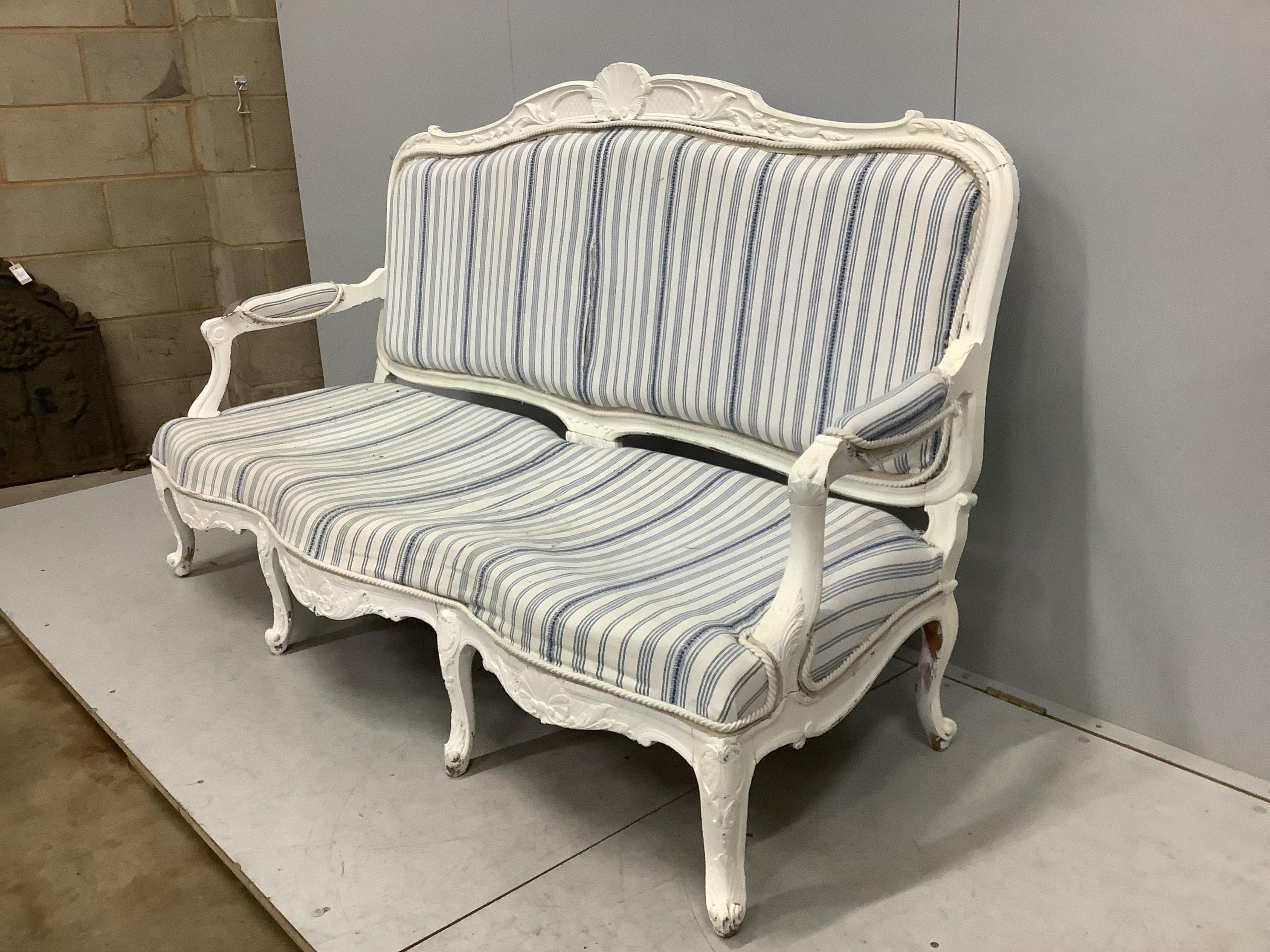 A Louis XVI style painted upholstered settee, width 180cm, depth 66cm, height 98cm. Condition - fair, upholstery poor